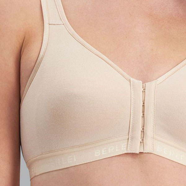Close-up view of the front of the Y130W Post Surgery Bra showing the hook and eye fastener, seamless cup, and medium band.