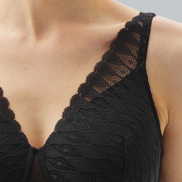 Close-up of the Megami Lotus adaptive wireless bra showing the higher upper cup and woder strap lace camisette bra effect.