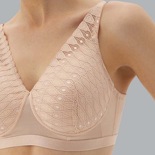 Front close-up of the nude Megami Lotus adaptive wireless bra showing the lace to the cup and straps, and band mesh detail.