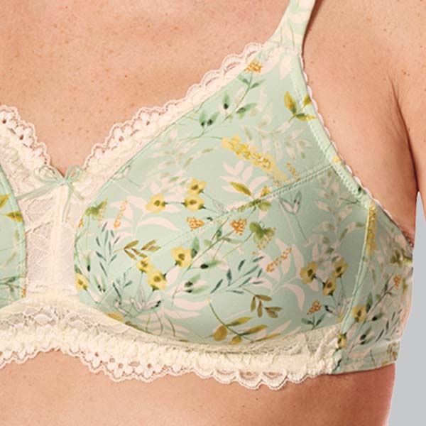 Front close-up of the Amoena Kalina soft wireless bra showing the lace upper cup and band, and lower cup floral fabric.