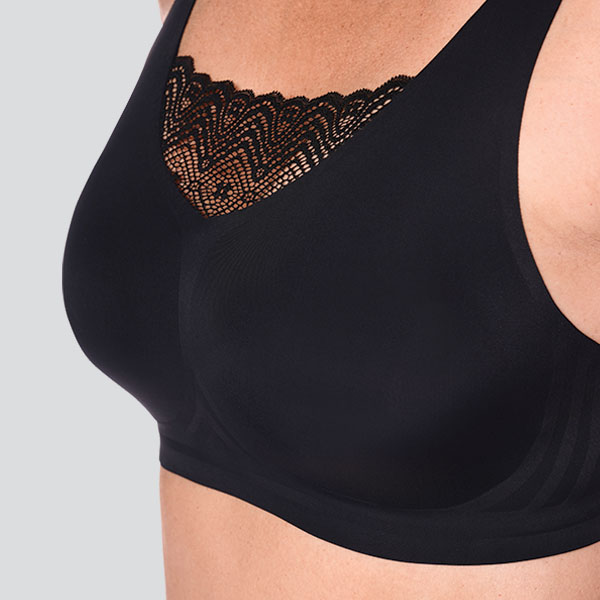 Side perspective of the Amoena Esra padded wireless mastectomy bra showing how camisette effect created by the lace infill.