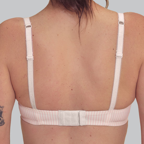 Back of the dust rose/off white Amoena Kennie padded wireless bra showing narrower band and straps.