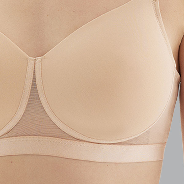 Front close-up of the nude Megami Luna t-shirt wireless bra showing seamless cup and mesh to the cleavage and band.
